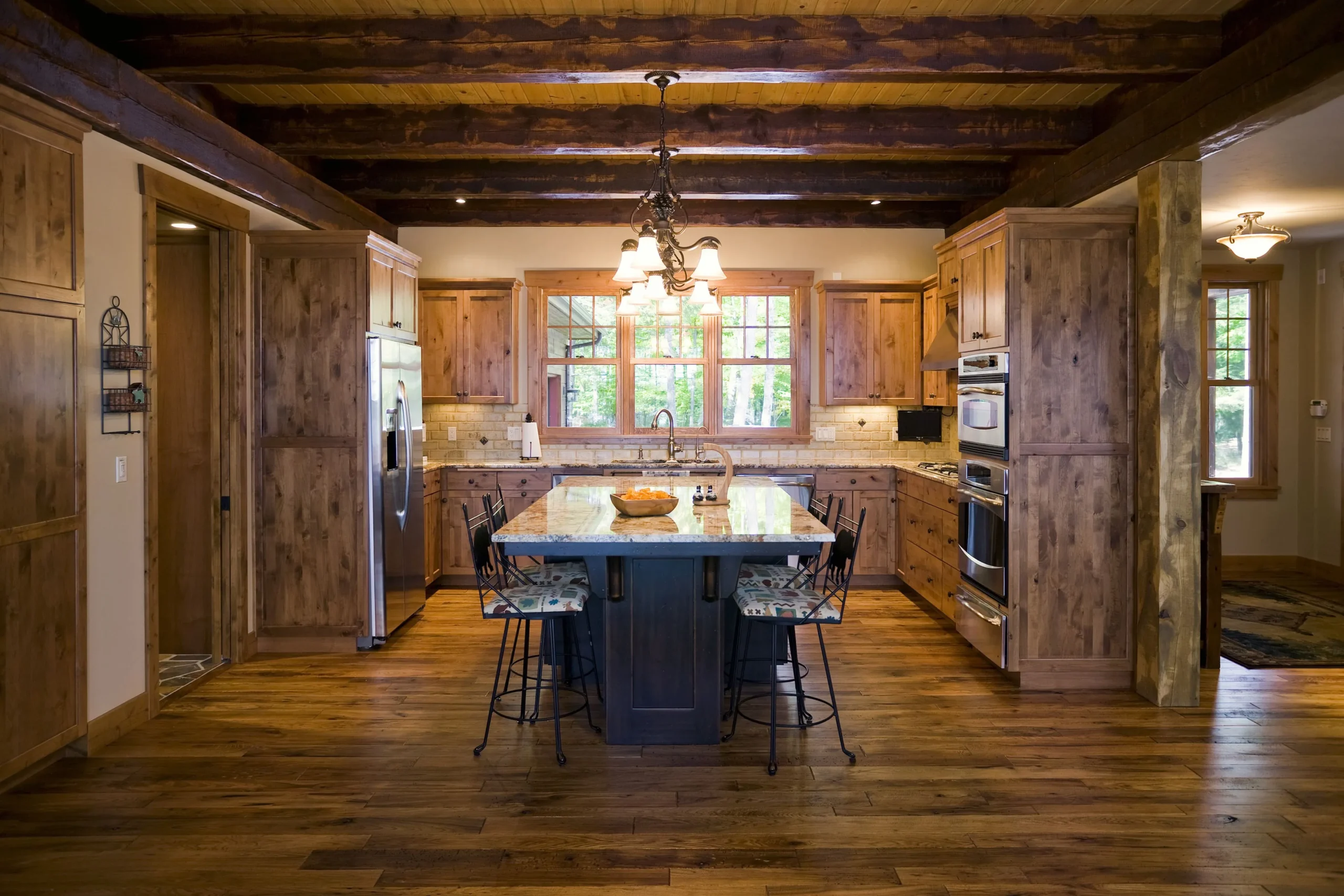 Kitchen-with-Wood-Floor-and-Open-Wood-Beam-Ceiling-88801427-Image-Studios-56a4a1615f9b58b7d0d7e63f