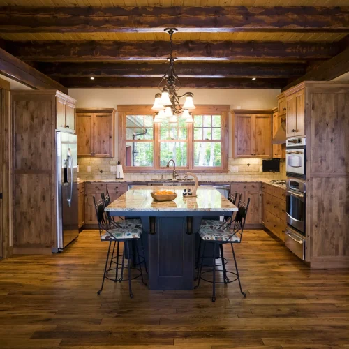 Kitchen-with-Wood-Floor-and-Open-Wood-Beam-Ceiling-88801427-Image-Studios-56a4a1615f9b58b7d0d7e63f